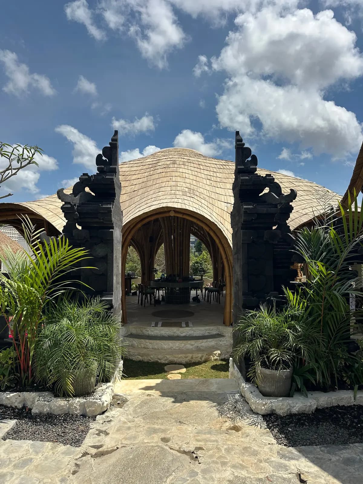 The carved candi gate of Bali Jewelry House opening onto the bamboo main house