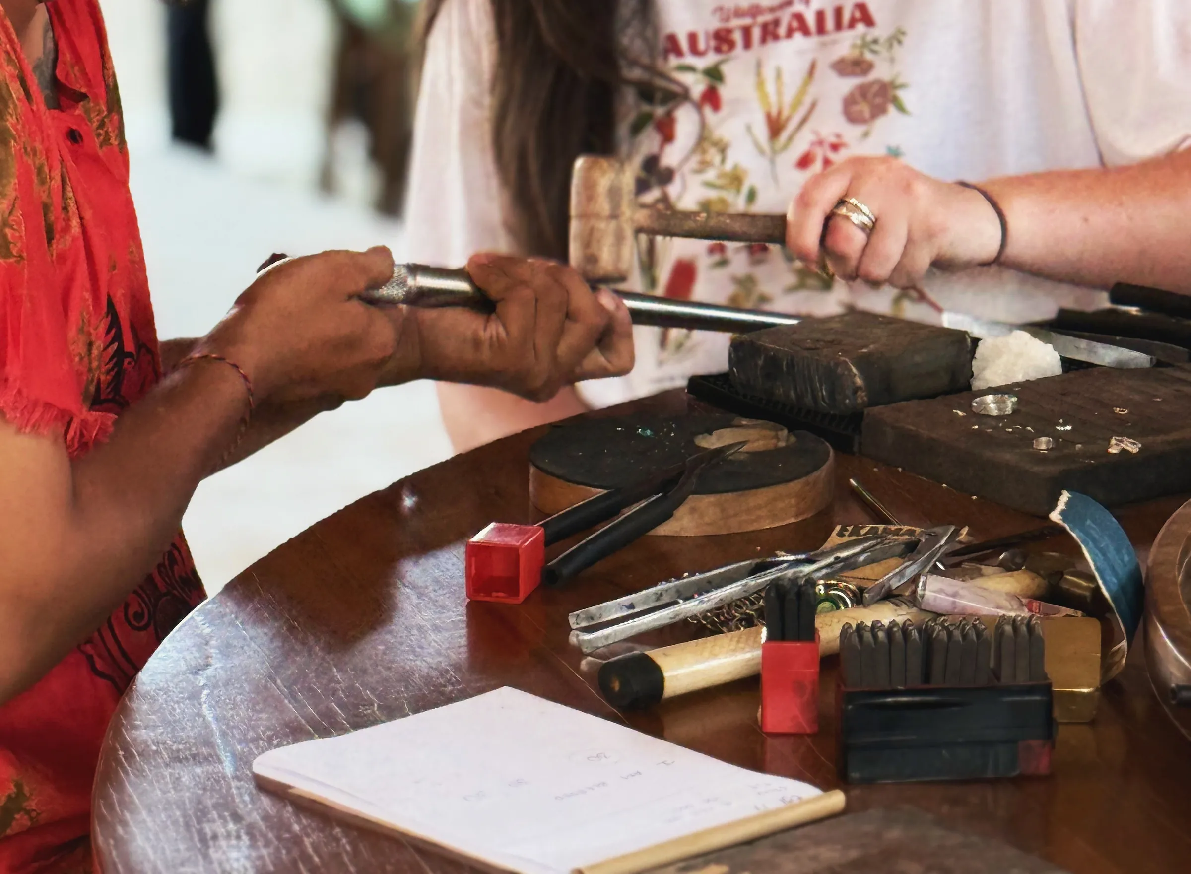 Tapping letters into silver with a hammer and punch