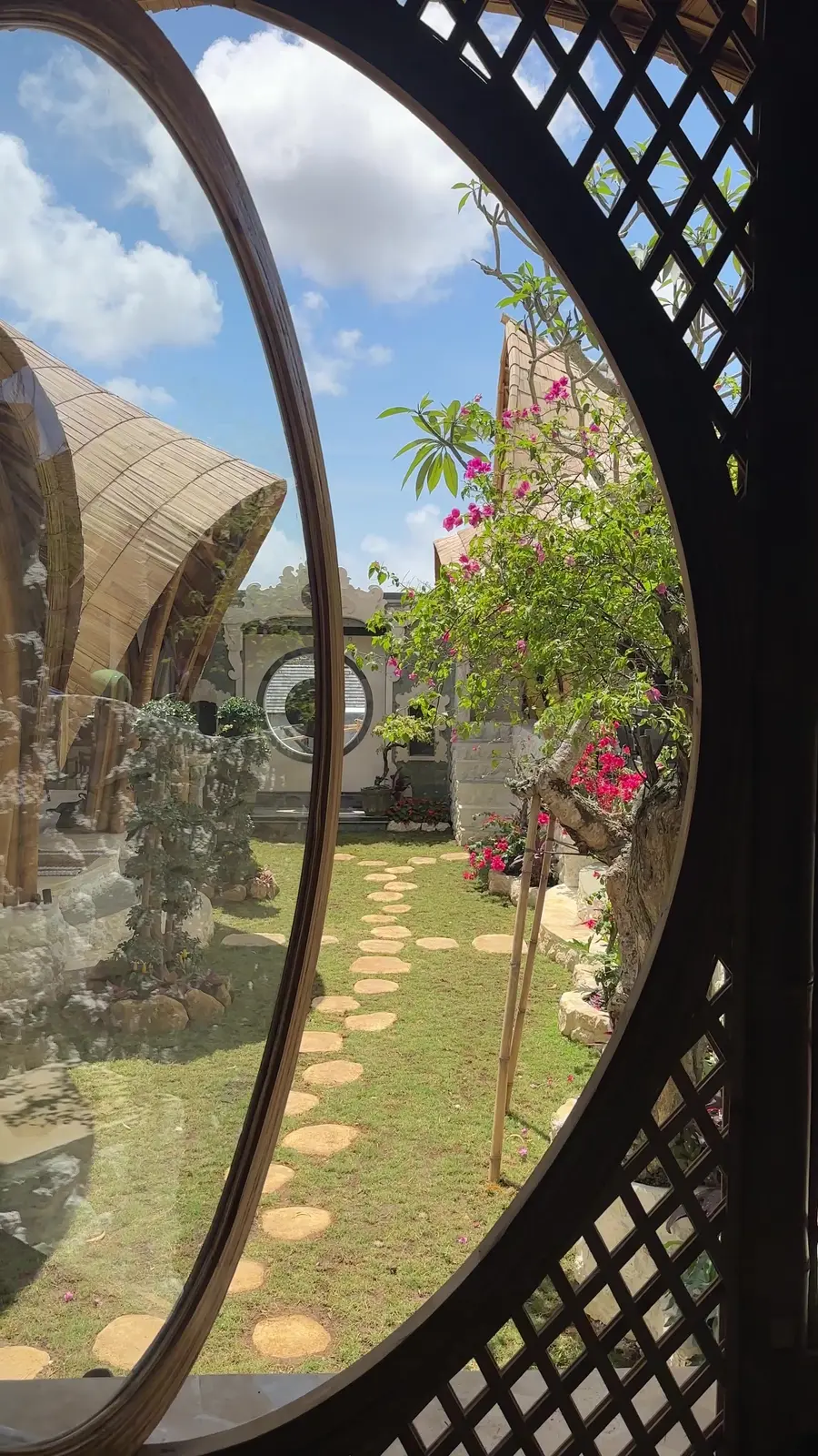 A round lattice window looking out onto the garden and the bamboo domes