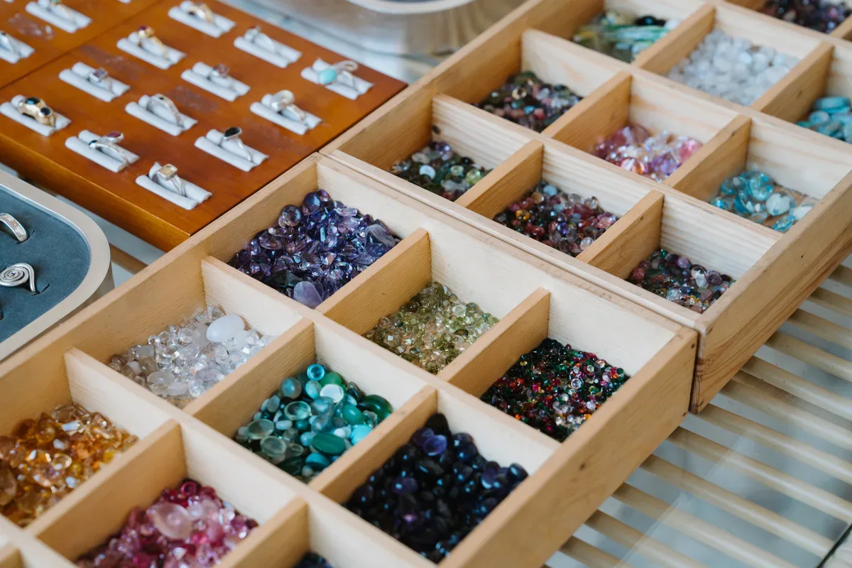 The studio tray of loose gemstones, sorted by colour