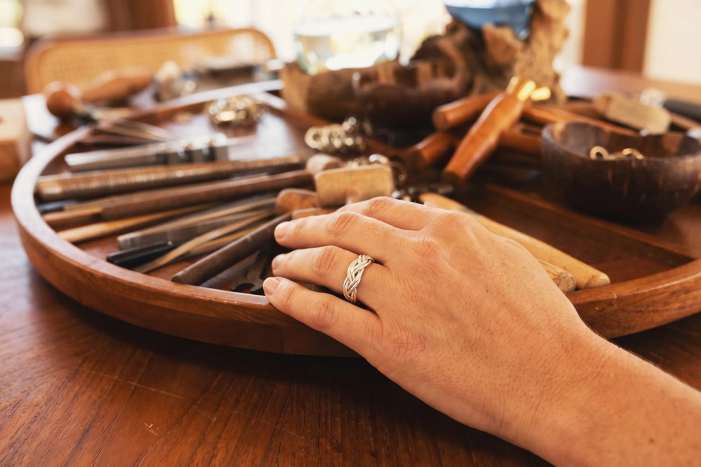 A hand-forged braided silver ring, worn straight from the bench