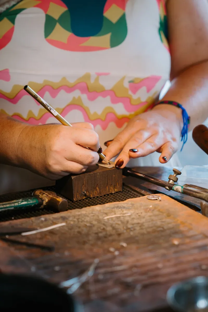 Stamping a pattern into silver on the bench block